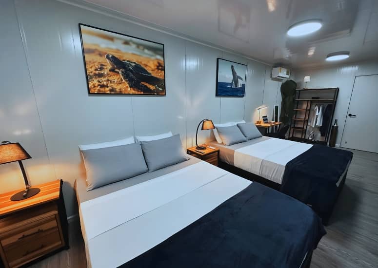 Cozy interior of Vivirí Beach Bungalows with two Queen beds, modern design, work desk and nature-inspired decor in Parrita Costa Rica